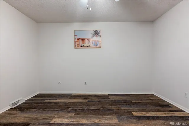 a view of a room with wooden floor and window