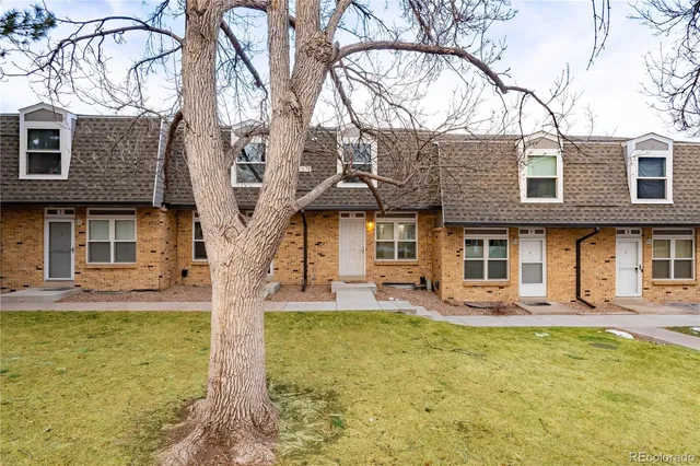 a front view of a house with swimming pool and furniture