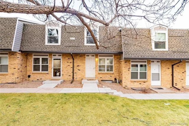 a front view of a house with swimming pool and sitting area