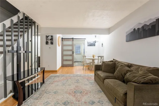 a living room with furniture and a rug