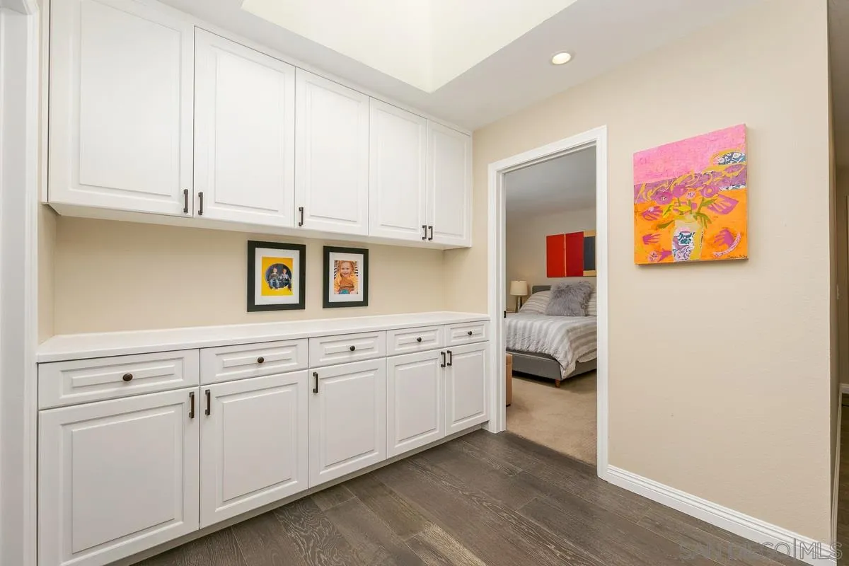 1122 Rancho Encinitas Drive Encinitas, CA 92024 - Photo 25 of 39 a hallway with cabinets and painting on the wall