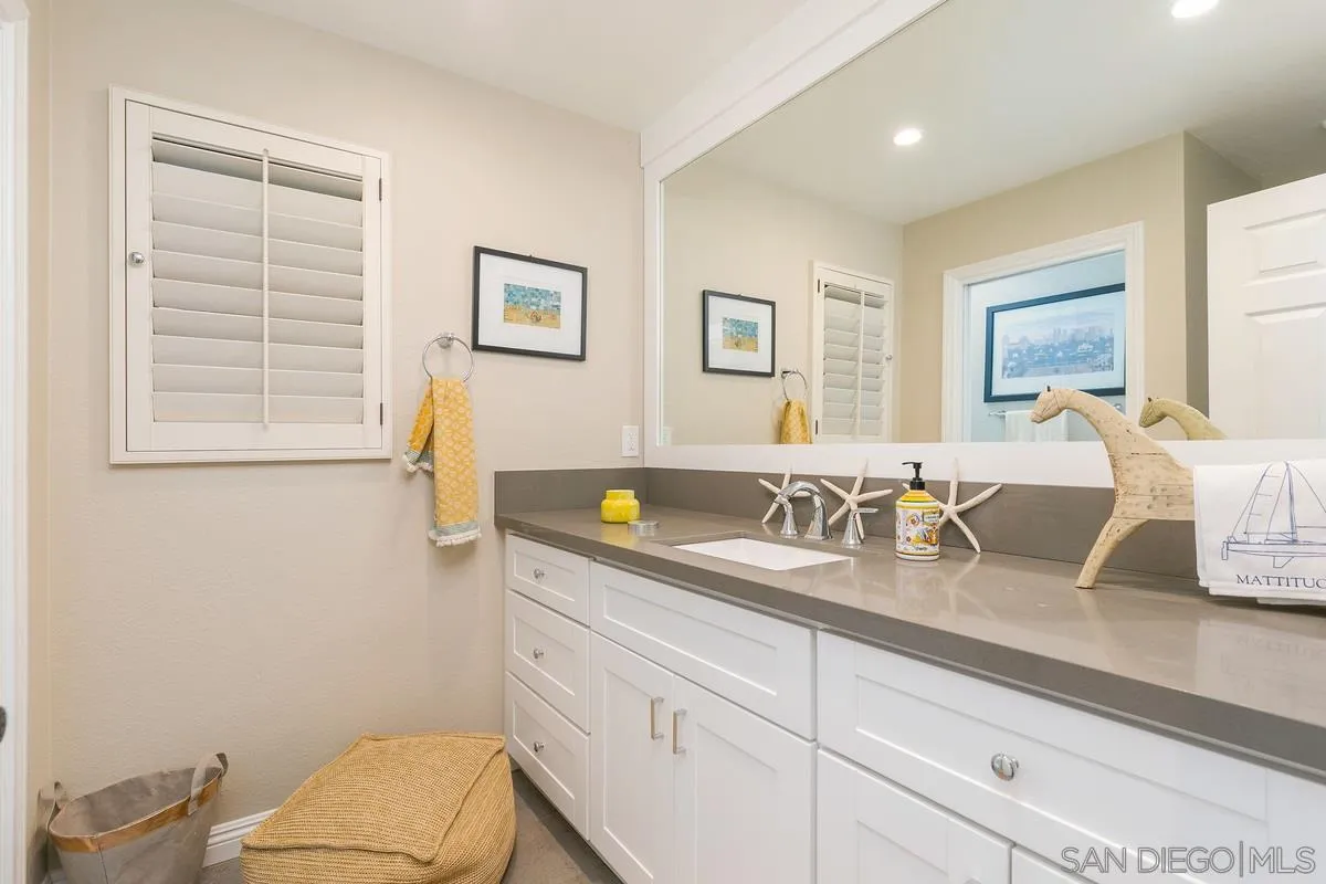 1122 Rancho Encinitas Drive Encinitas, CA 92024 - Photo 30 of 39 a bathroom with a granite countertop sink mirror vanity and toilet