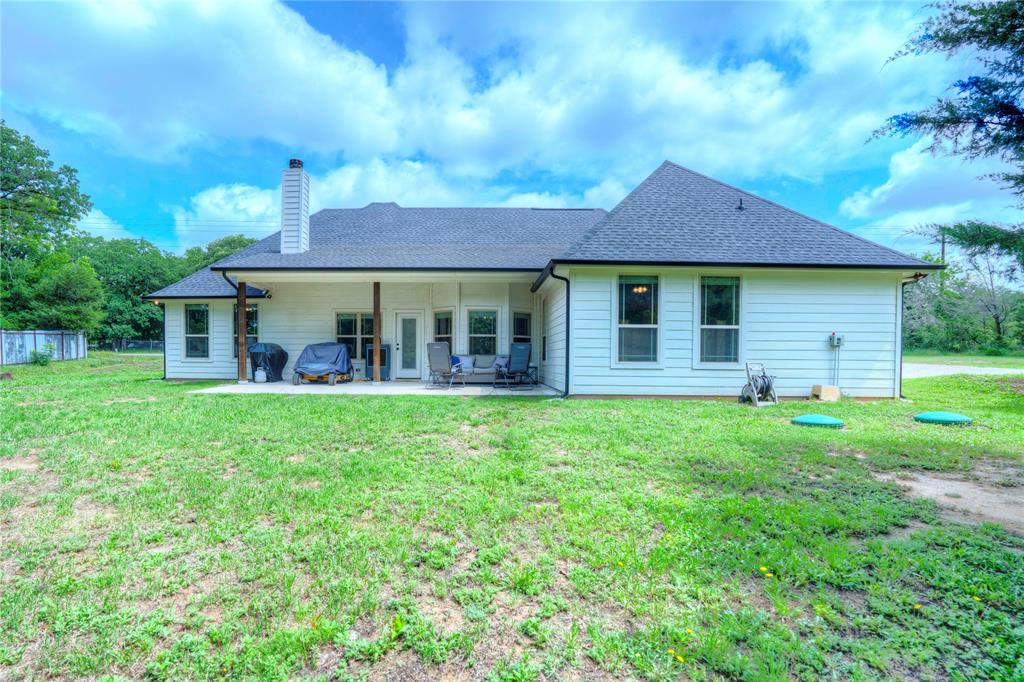 1355 Jay Bird Road Springtown, TX 76082 - Photo 36 of 40 a view of a house with a yard