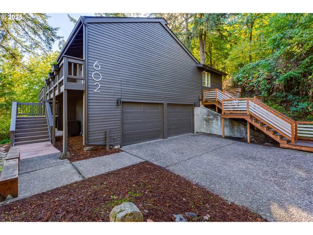 a view of house with backyard and deck