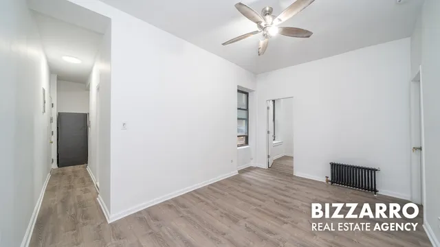 a view of a hallway with a chandelier fan