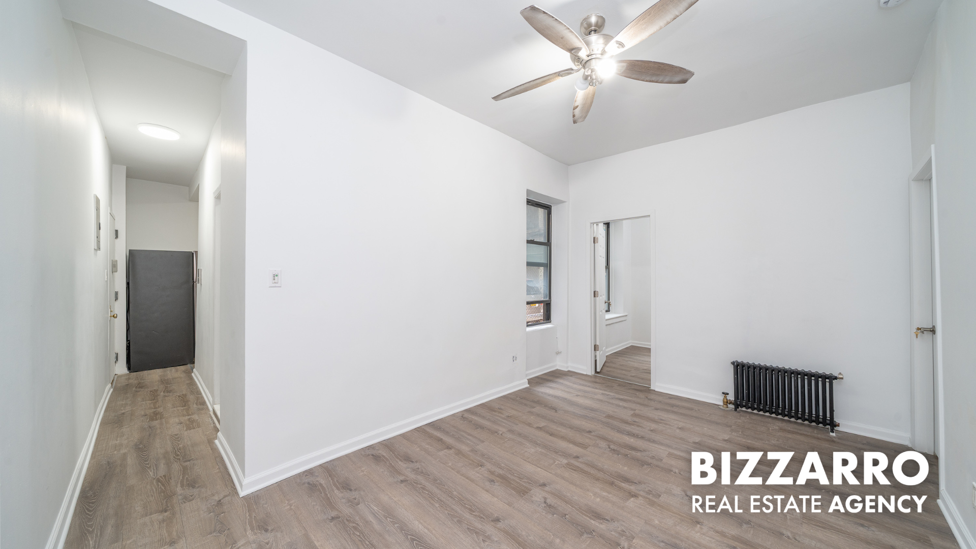 a view of a hallway with a chandelier fan
