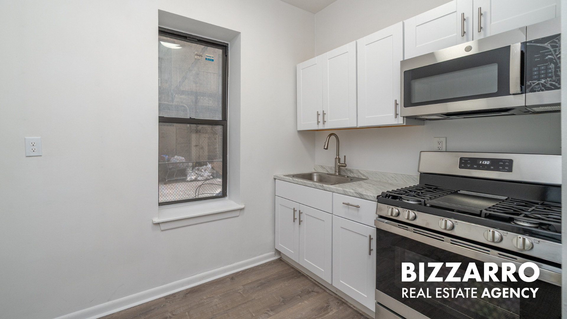 Undisclosed Address Manhattan, NY 10031 - Photo 12 of 20 a kitchen with stainless steel appliances granite countertop a stove and a microwave