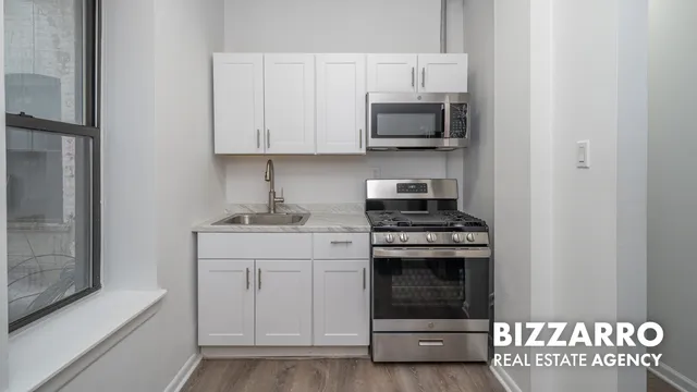 a kitchen with stainless steel appliances granite countertop a stove and a microwave
