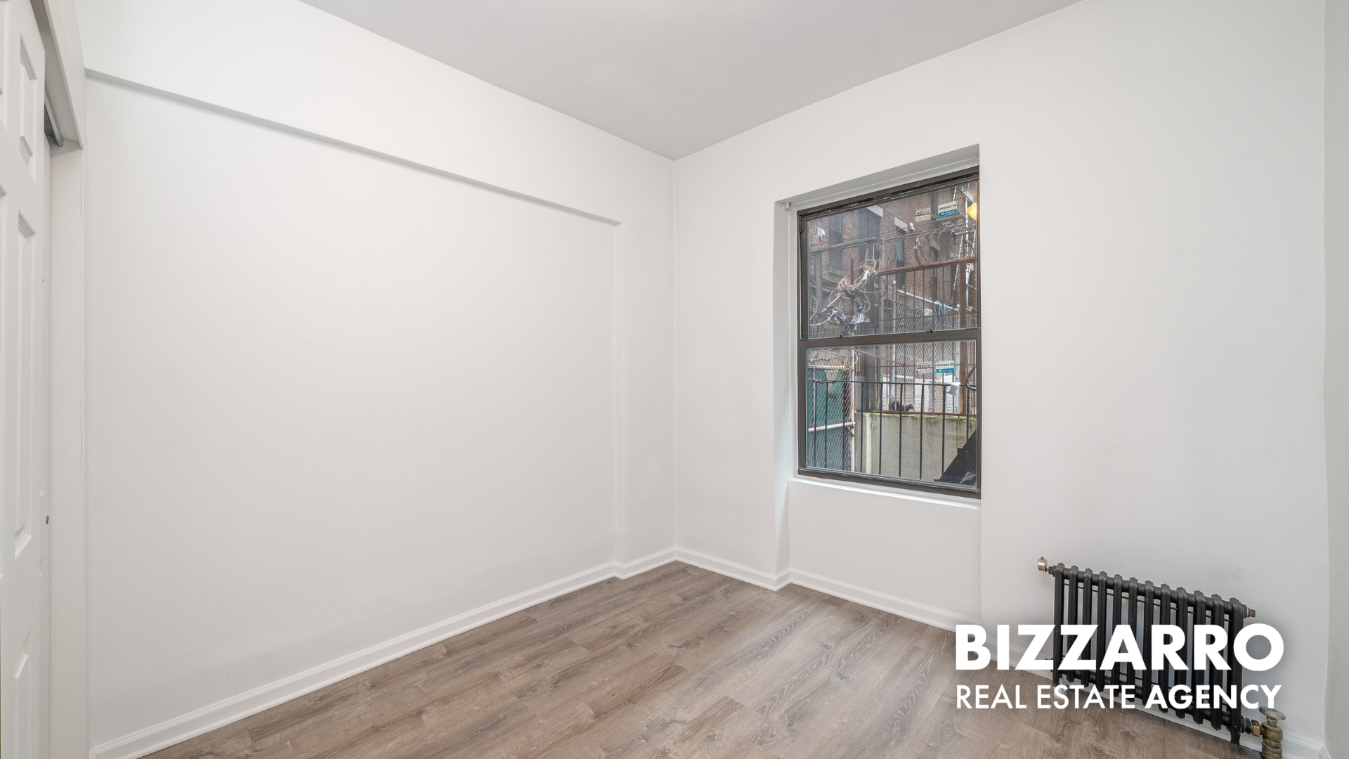 Undisclosed Address Manhattan, NY 10031 - Photo 7 of 20 a view of an empty room with wooden floor and a window