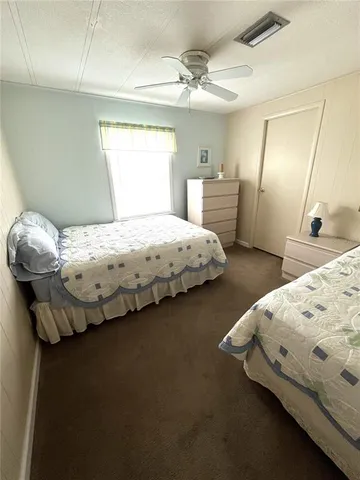 a view of a swimming pool with a lawn chairs under an umbrella
