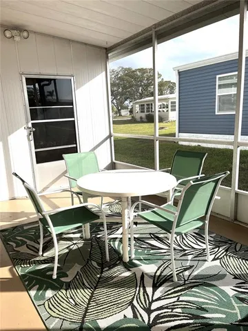 a living room with furniture a rug and a book shelf