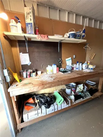 a view of a kitchen with refrigerator and windows