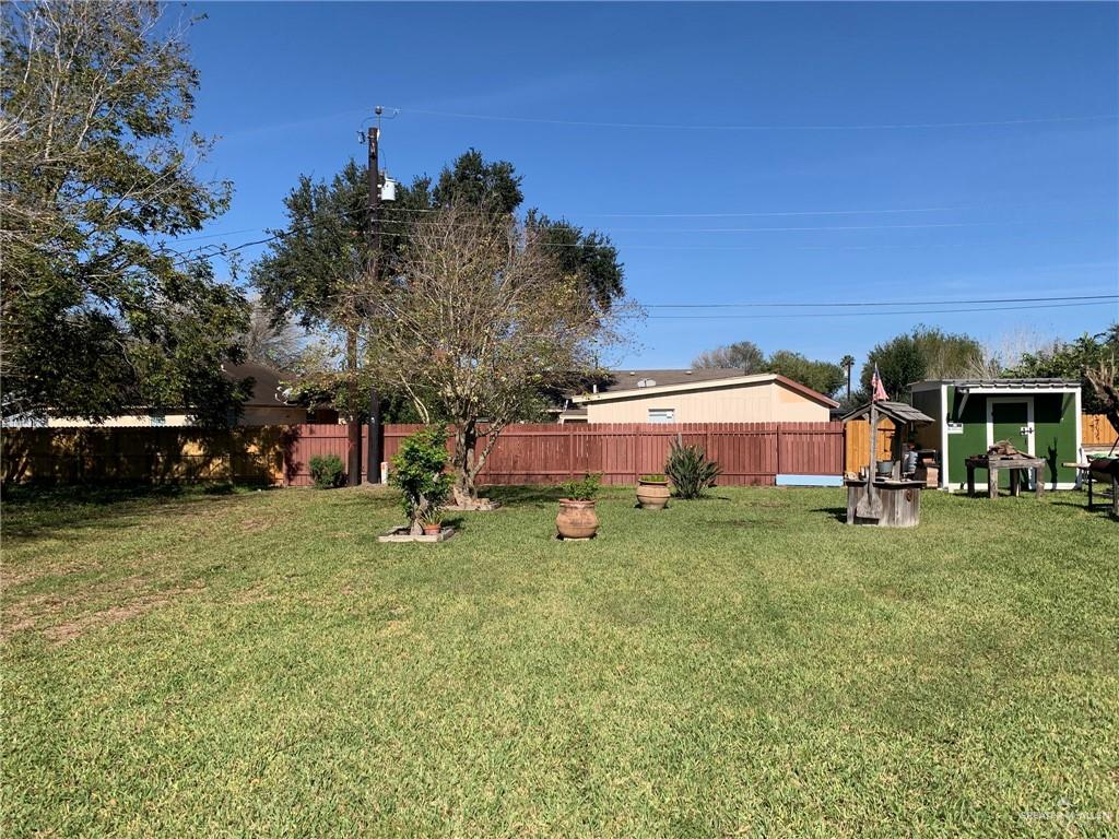0 Wayne Place Harlingen, TX 78552 - Photo 10 of 11 a front view of a house with a garden and trees