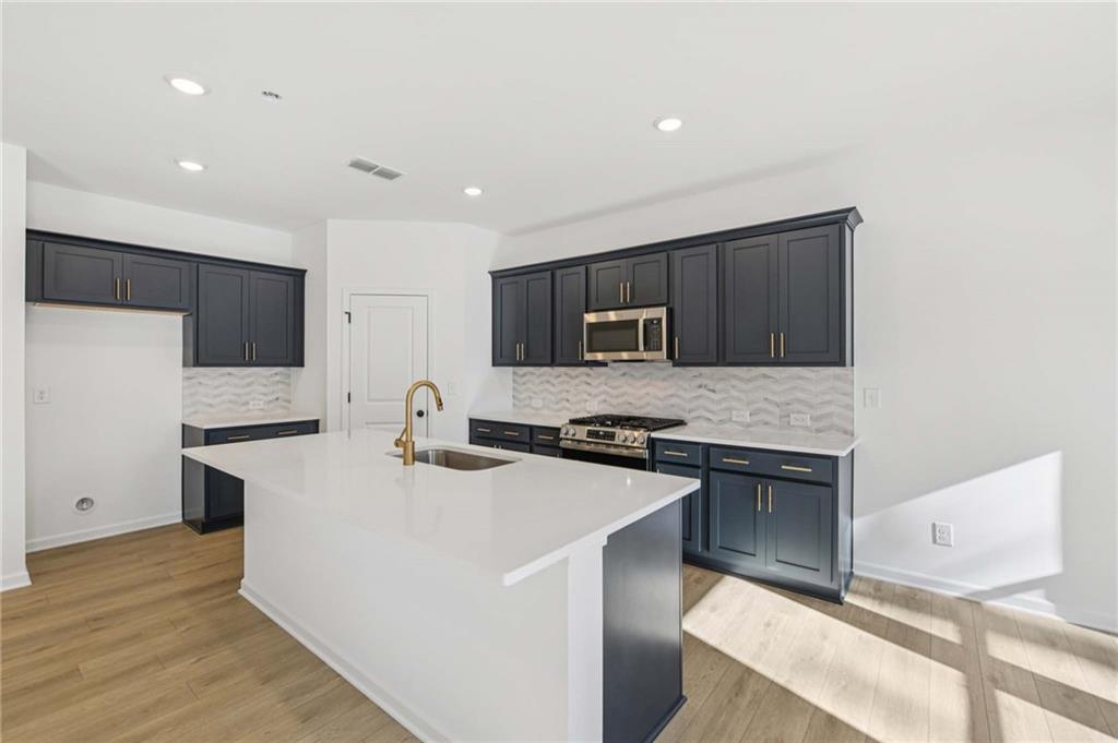280 Silverleaf Trail Bethlehem, GA 30620 - Photo 12 of 40 a kitchen with stainless steel appliances a sink stove and refrigerator