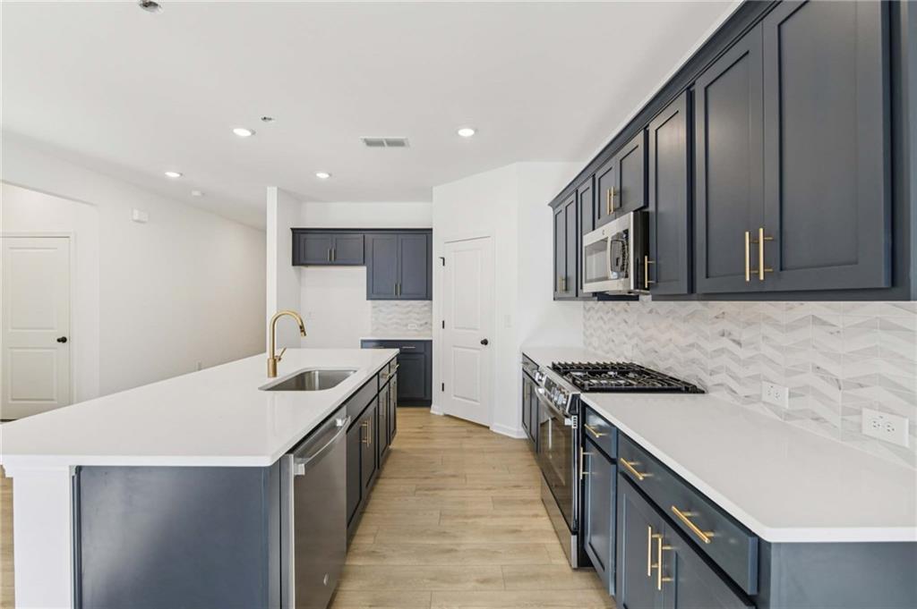 280 Silverleaf Trail Bethlehem, GA 30620 - Photo 13 of 40 a kitchen with stainless steel appliances a sink stove and cabinets