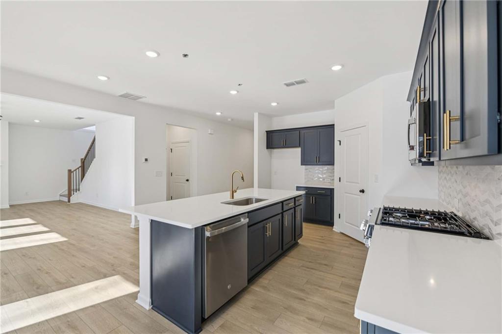 280 Silverleaf Trail Bethlehem, GA 30620 - Photo 14 of 40 a kitchen with stainless steel appliances granite countertop a stove a sink and a refrigerator