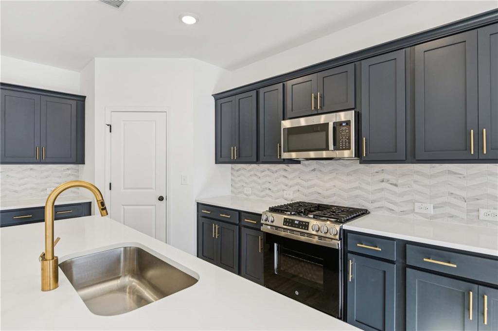 280 Silverleaf Trail Bethlehem, GA 30620 - Photo 15 of 40 a kitchen with granite countertop a sink stainless steel appliances and cabinets