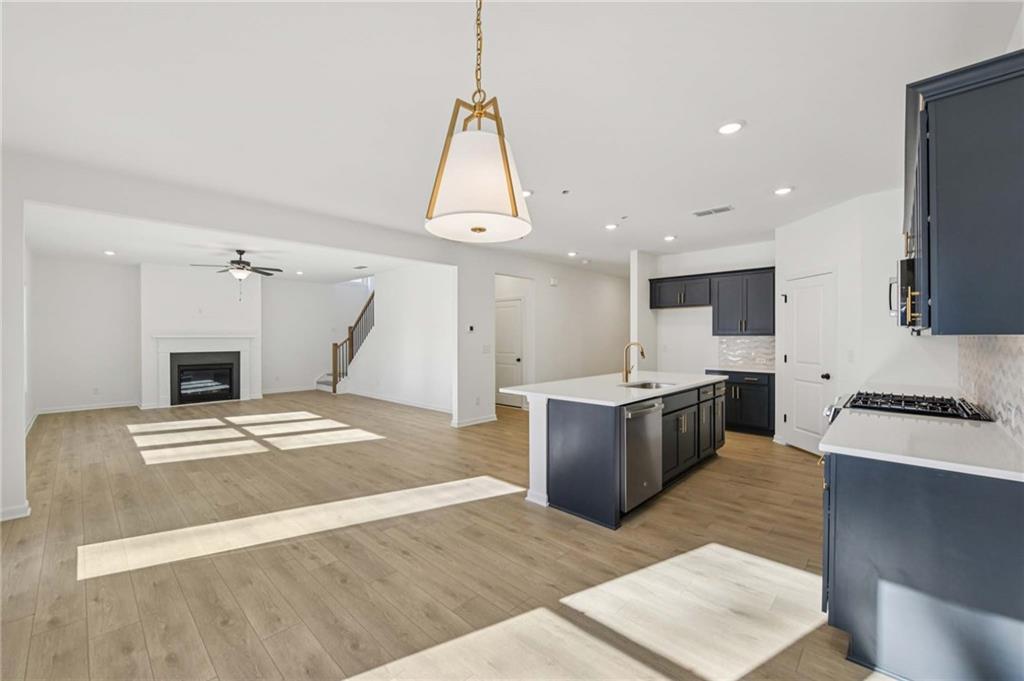 280 Silverleaf Trail Bethlehem, GA 30620 - Photo 18 of 40 a large kitchen with kitchen island a stove a sink a oven and a refrigerator with wooden floor