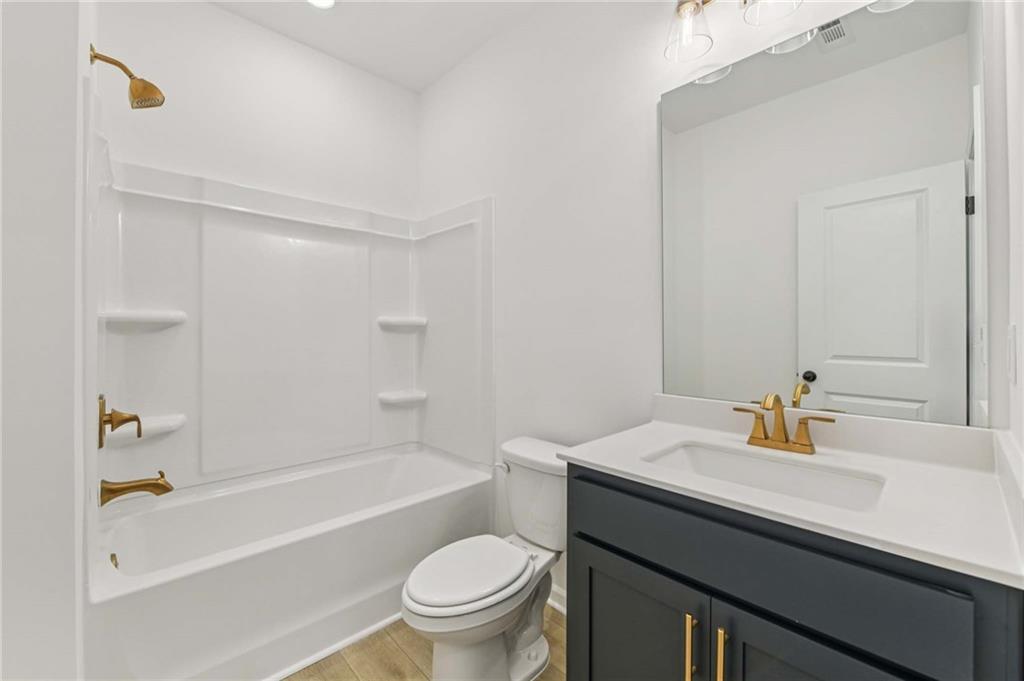 280 Silverleaf Trail Bethlehem, GA 30620 - Photo 19 of 40 a bathroom with a sink a toilet and shower