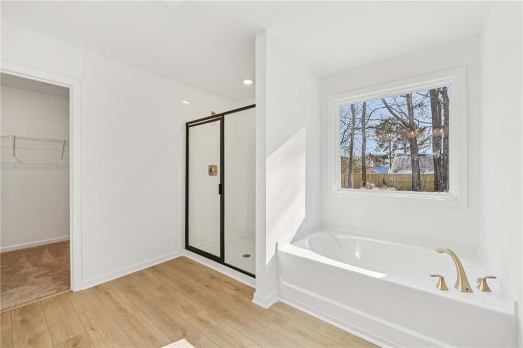 280 Silverleaf Trail Bethlehem, GA 30620 - Photo 36 of 40 a bathroom with a bathtub and a shower