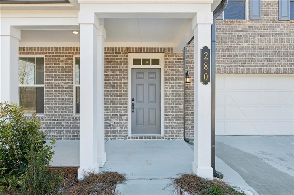 280 Silverleaf Trail Bethlehem, GA 30620 - Photo 4 of 40 a front view of a house with a glass door