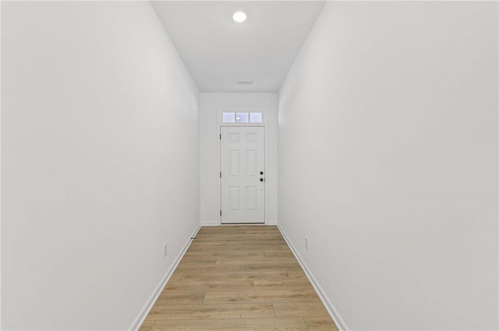 280 Silverleaf Trail Bethlehem, GA 30620 - Photo 5 of 40 a view of a hallway with wooden floor