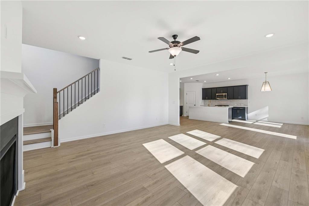 280 Silverleaf Trail Bethlehem, GA 30620 - Photo 7 of 40 a view of empty room with wooden floor and fan