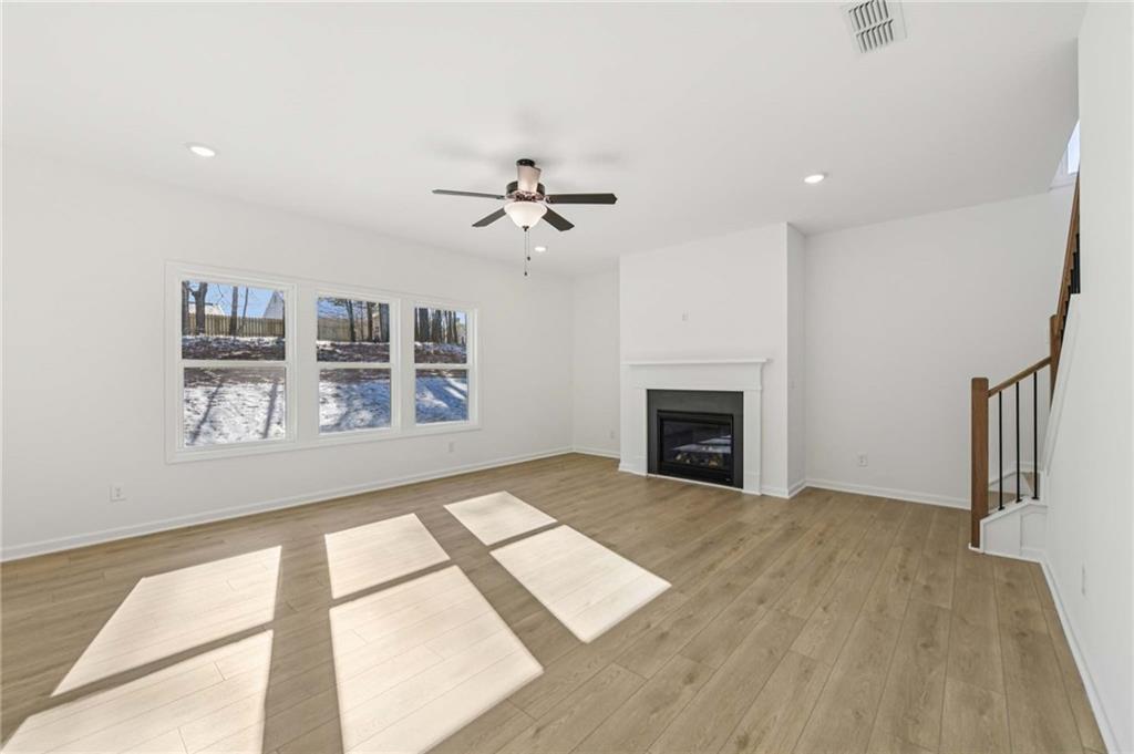 280 Silverleaf Trail Bethlehem, GA 30620 - Photo 9 of 40 a view of an empty room with a fireplace and a window