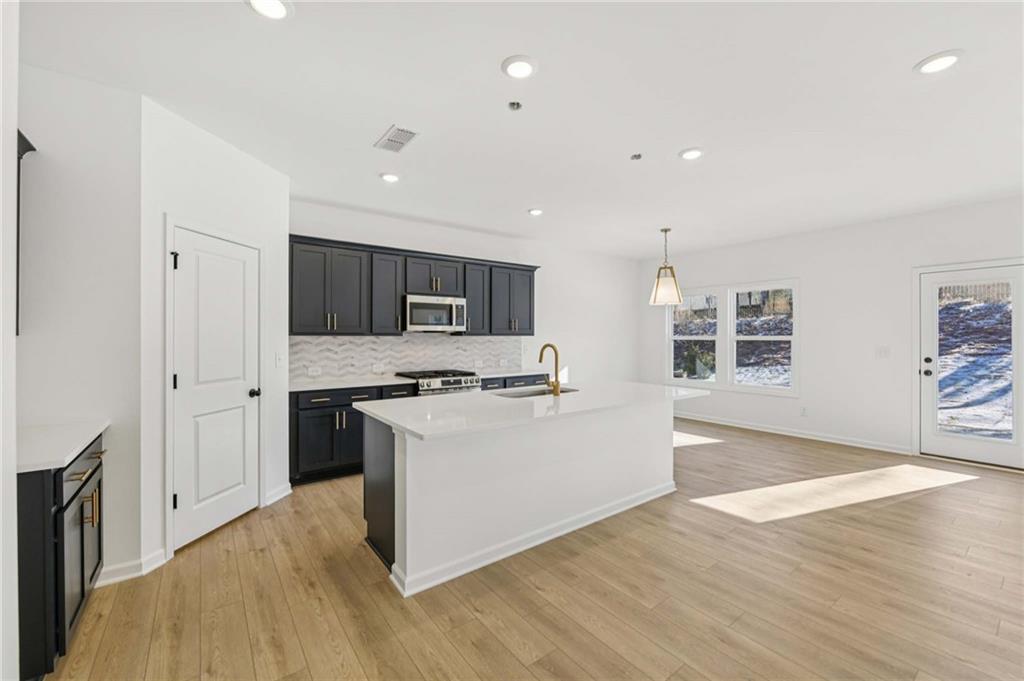 280 Silverleaf Trail Bethlehem, GA 30620 - Photo 10 of 40 a large kitchen with stainless steel appliances granite countertop a stove and a refrigerator