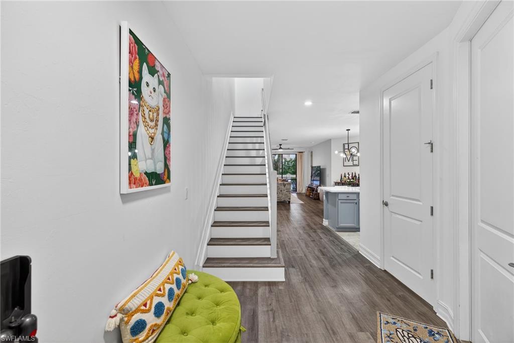 7845 Bristol Circle Naples, FL 34120 - Photo 2 of 31 a view of entryway with stairs and wooden floor