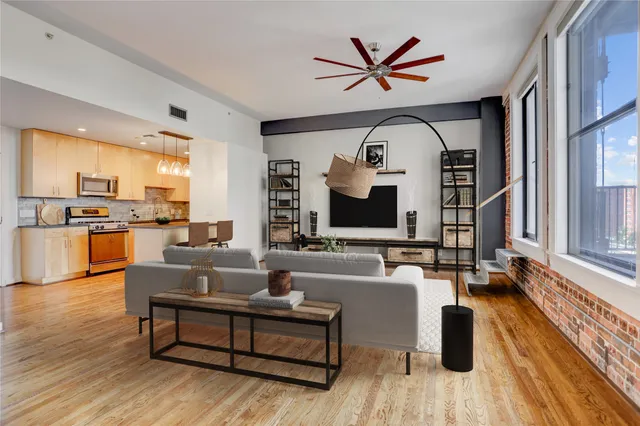 a living room with furniture and a large window