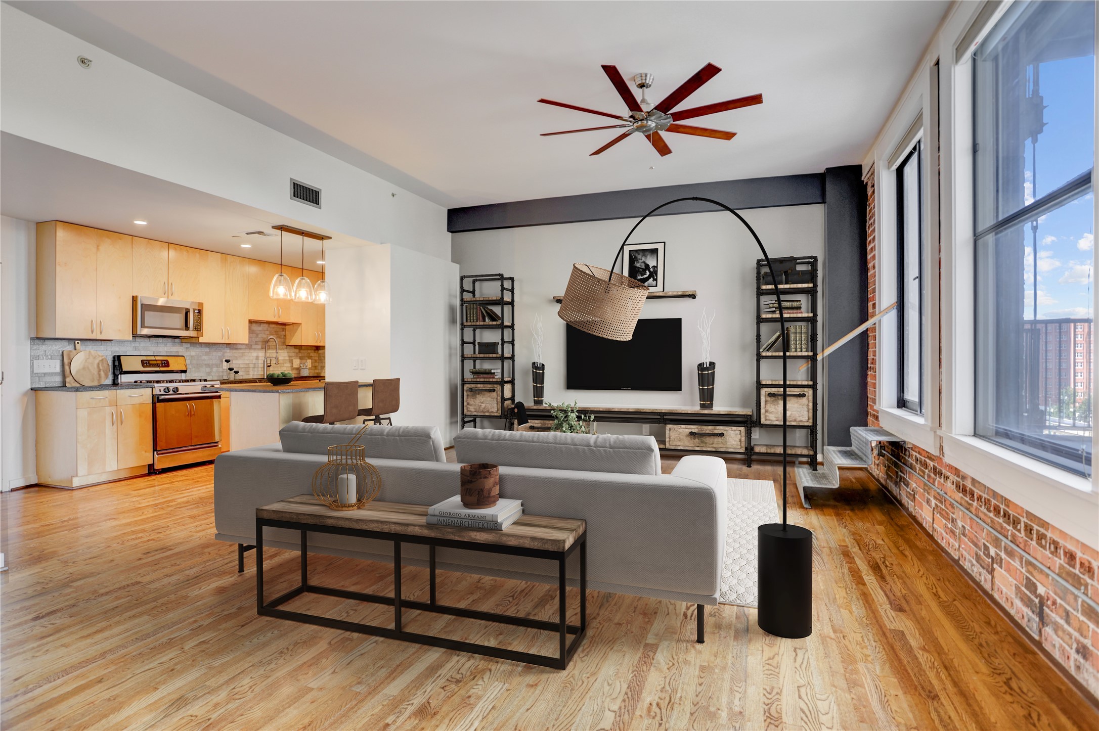 a living room with furniture fireplace and a large window