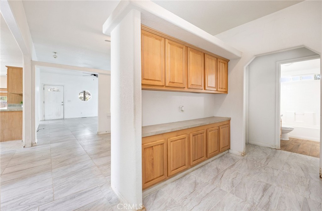 43870 Wilson Valley Road Hemet, CA 92544 - Photo 13 of 35 a view of a kitchen with wooden floor and cabinets