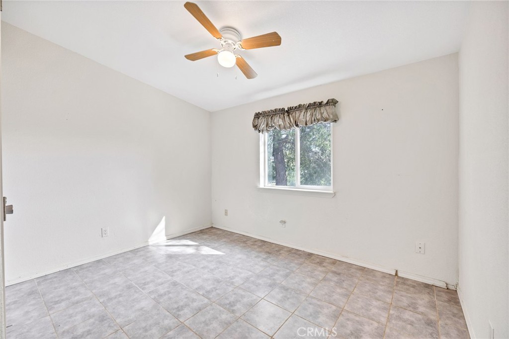 43870 Wilson Valley Road Hemet, CA 92544 - Photo 14 of 35 an empty room with a window and a fan