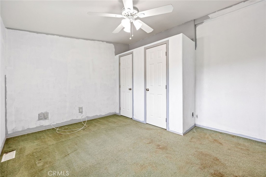 43870 Wilson Valley Road Hemet, CA 92544 - Photo 18 of 35 an empty room with a ceiling fan and a window