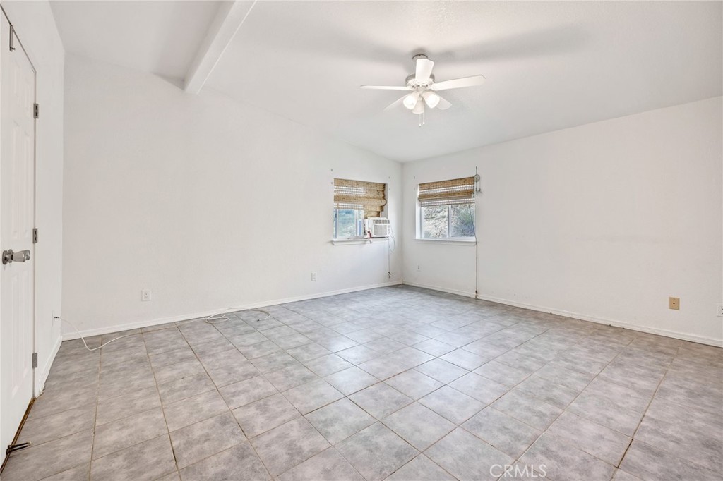 43870 Wilson Valley Road Hemet, CA 92544 - Photo 19 of 35 an empty room with windows and chandelier fan