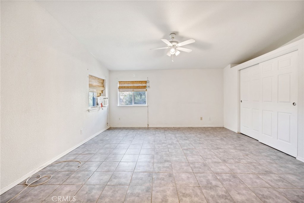 43870 Wilson Valley Road Hemet, CA 92544 - Photo 24 of 35 an empty room with windows and fan