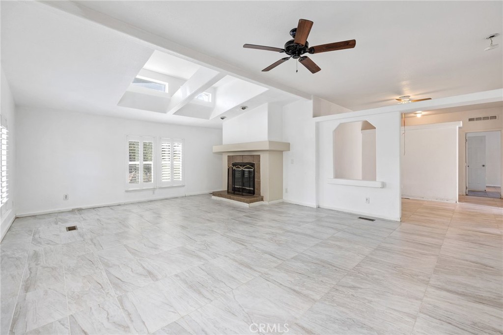 43870 Wilson Valley Road Hemet, CA 92544 - Photo 6 of 35 a view of a livingroom with a ceiling fan a fireplace and a ceiling fan