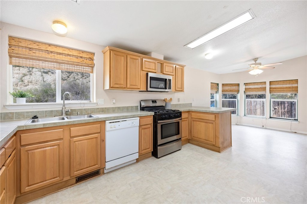 43870 Wilson Valley Road Hemet, CA 92544 - Photo 7 of 35 a kitchen with sink a stove and cabinets