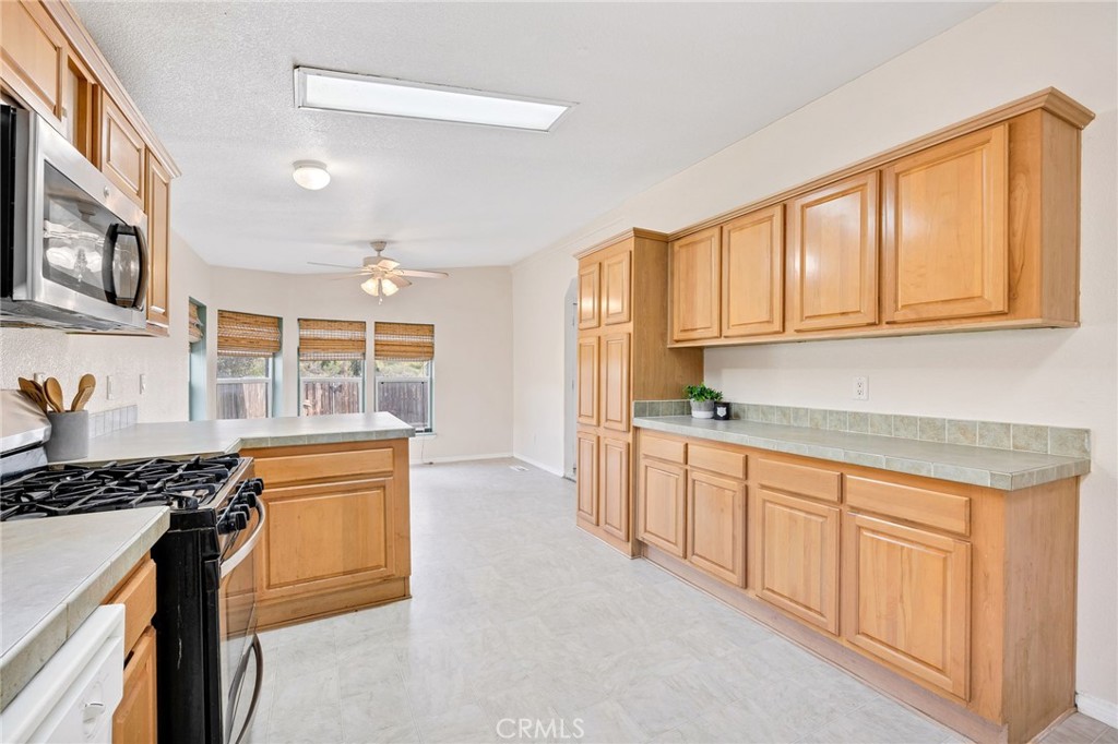 43870 Wilson Valley Road Hemet, CA 92544 - Photo 9 of 35 a kitchen with stainless steel appliances granite countertop a stove a sink and a refrigerator