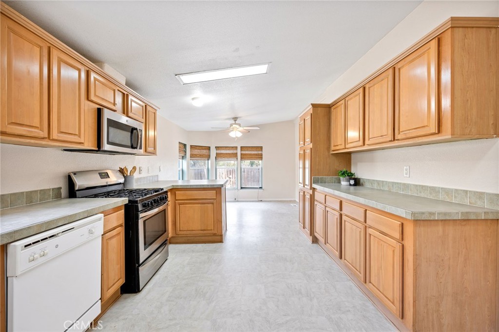 43870 Wilson Valley Road Hemet, CA 92544 - Photo 10 of 35 a kitchen with stainless steel appliances granite countertop a stove and a sink