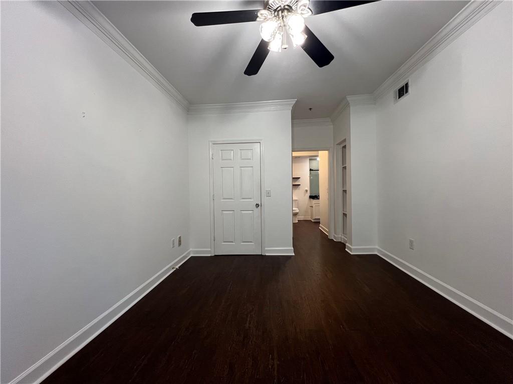 3777 Peachtree Road Northeast, Unit 1116 Brookhaven, GA 30319 - Photo 11 of 28 wooden floor in an empty room with a window