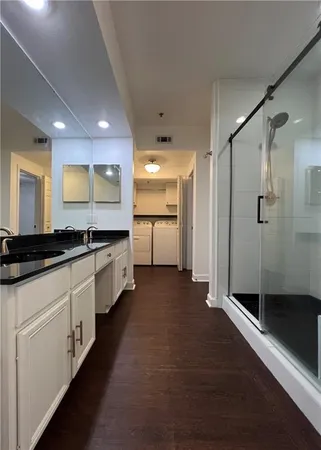 a large bathroom with a double vanity sink and a mirror