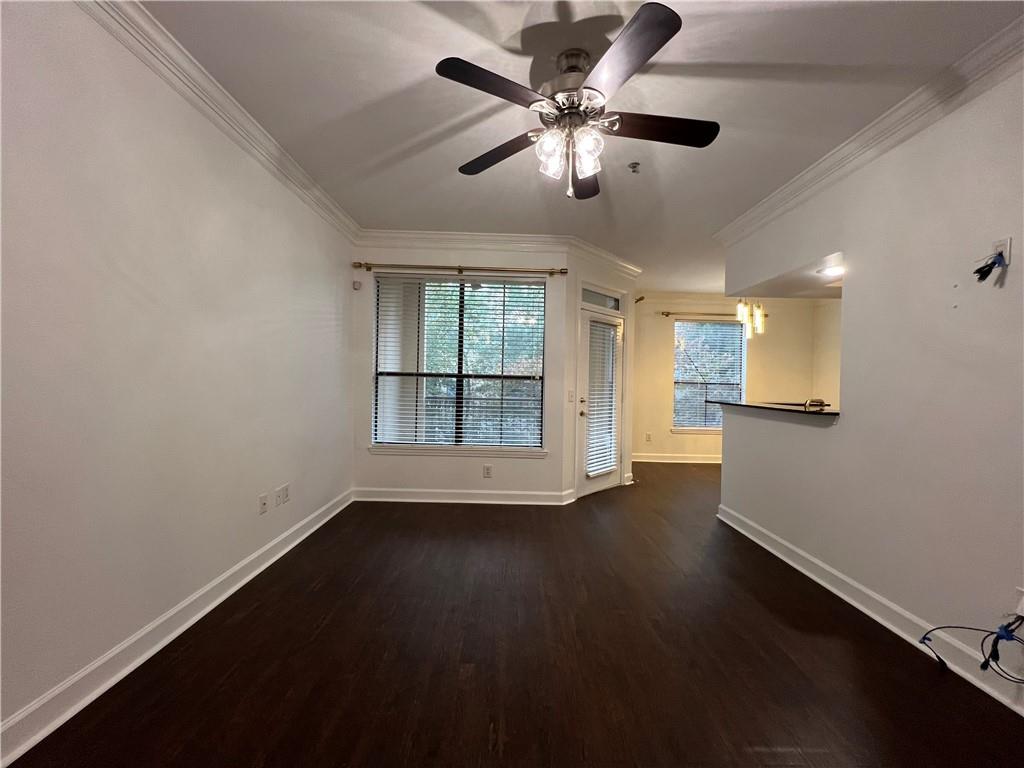 3777 Peachtree Road Northeast, Unit 1116 Brookhaven, GA 30319 - Photo 3 of 28 an empty room with wooden floor and windows
