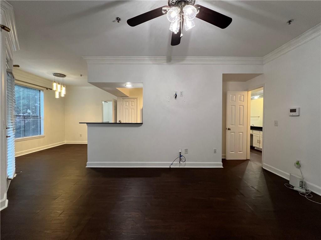3777 Peachtree Road Northeast, Unit 1116 Brookhaven, GA 30319 - Photo 4 of 28 an empty room with wooden floor and windows