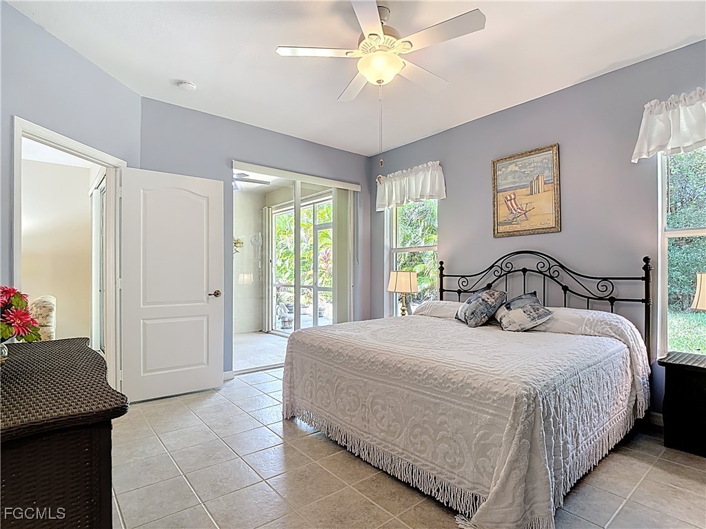 3600 Rue Alec Loop, Unit 4 North Fort Myers, FL 33917 - Photo 18 of 43 a bedroom with a bed and a chandelier