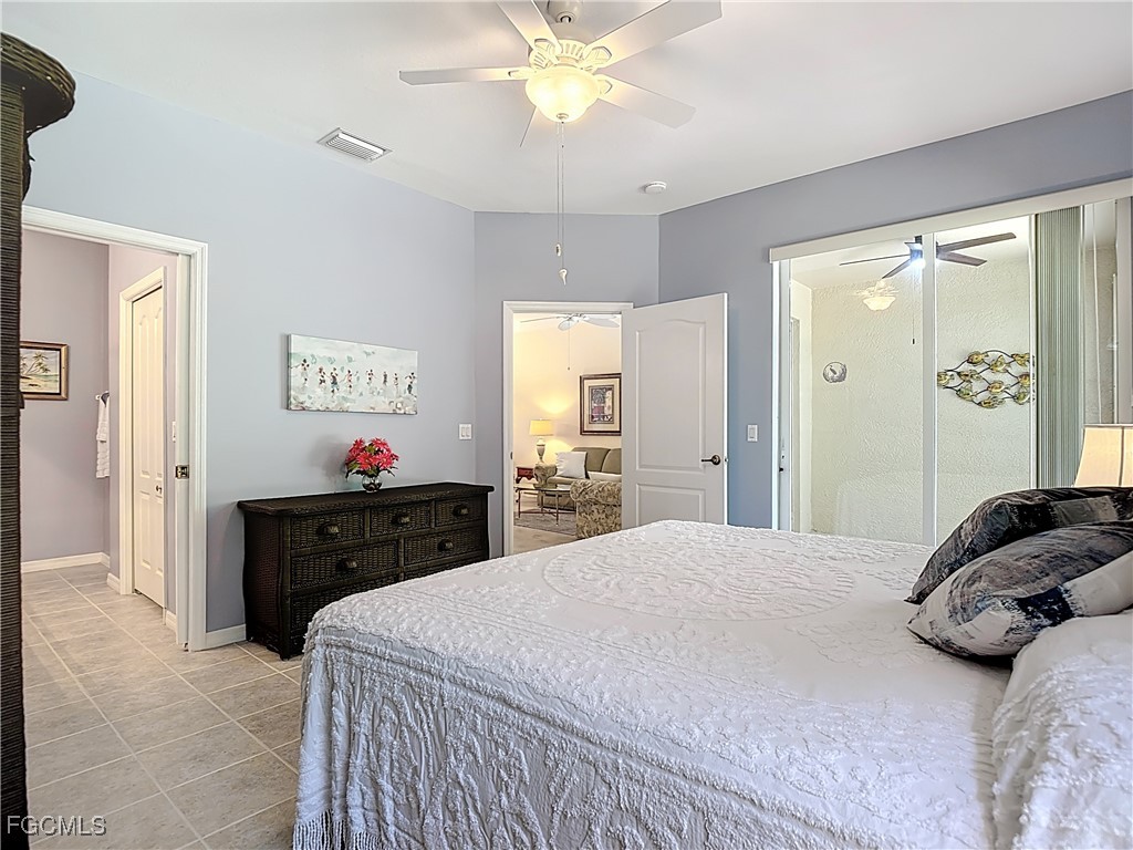 3600 Rue Alec Loop, Unit 4 North Fort Myers, FL 33917 - Photo 19 of 43 a bedroom with a bed and a chandelier