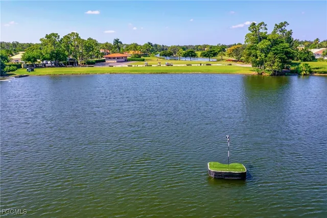 an aerial view of a house with a garden and lake view