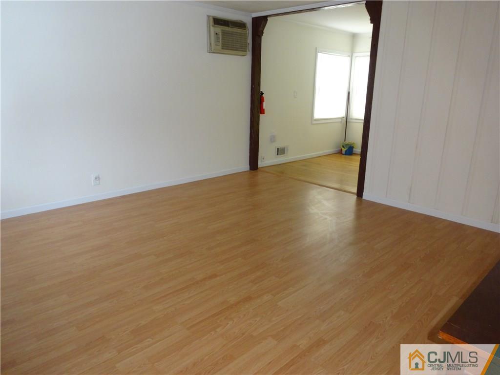 25 Sturgis Road Edison, NJ 08817 - Photo 2 of 8 an empty room with wooden floor and mirror