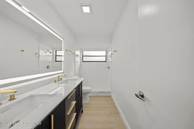 a bathroom with a sink a vanity and a mirror